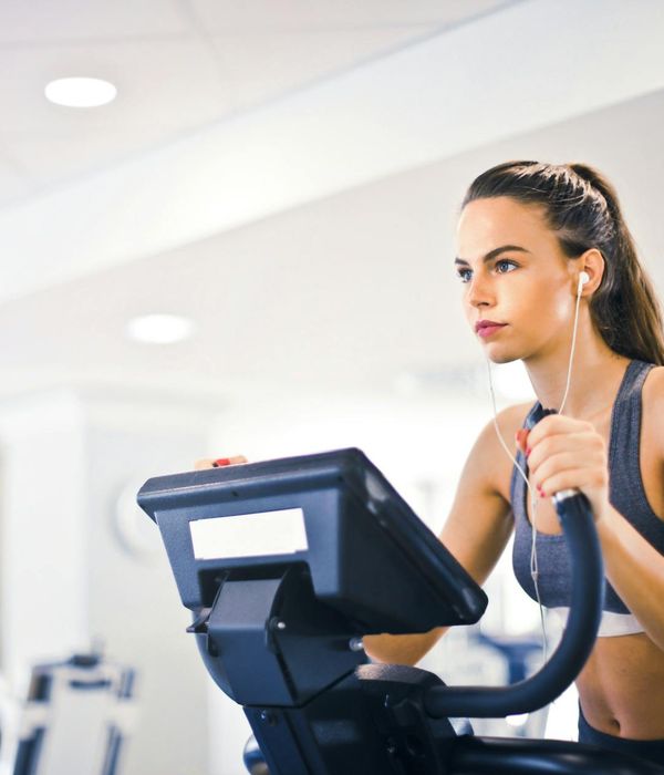 Woman performing active cardiovascular exercise in a modern dark studio